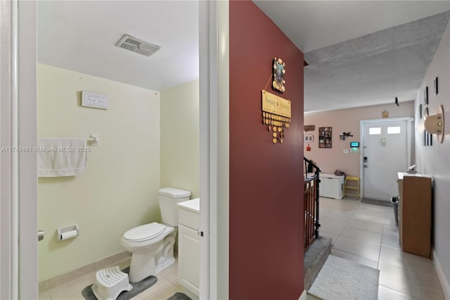 hallway with visible vents and light tile patterned floors