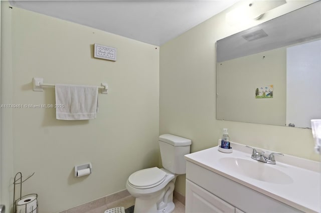 bathroom with vanity, toilet, and tile patterned floors