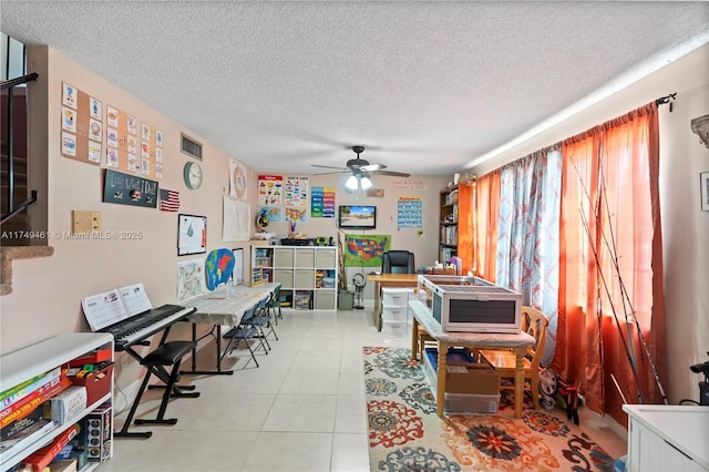 office space featuring a ceiling fan, a textured ceiling, and light tile patterned floors