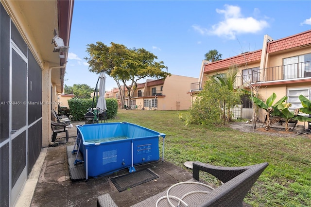 view of pool with a lawn