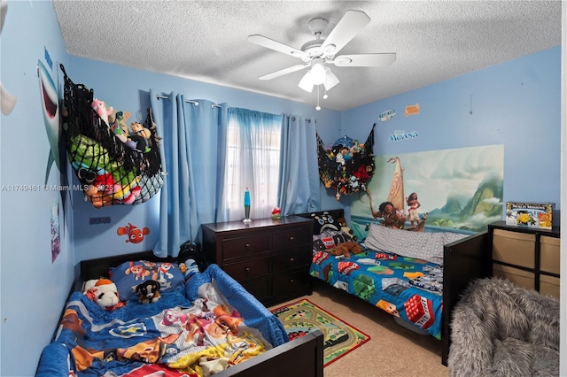 bedroom featuring light carpet, a ceiling fan, and a textured ceiling