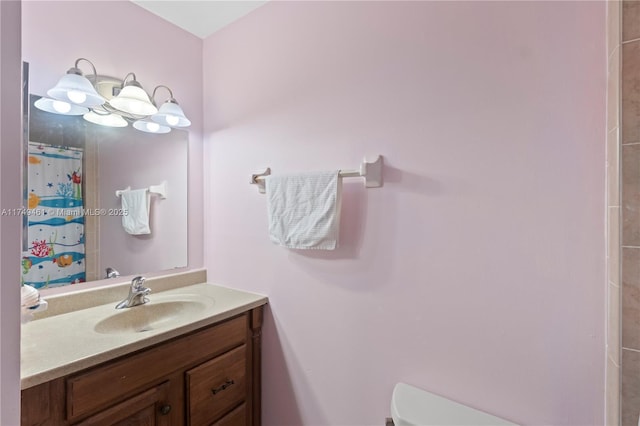 full bath featuring toilet, curtained shower, and vanity