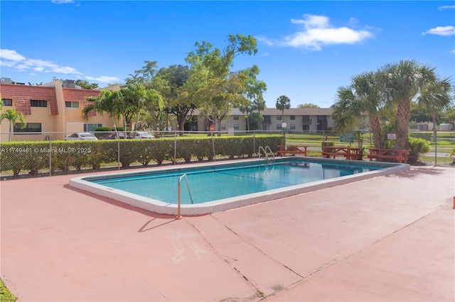 pool featuring a patio area and fence