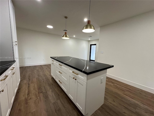 kitchen featuring hanging light fixtures, dark countertops, and white cabinets