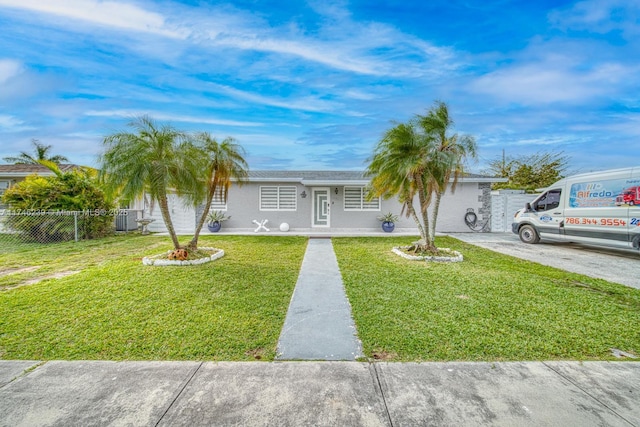 single story home with fence, a front lawn, and central AC unit