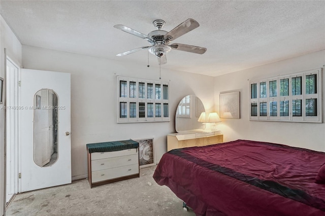 bedroom with concrete floors, a ceiling fan, and a textured ceiling