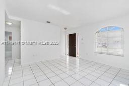 spare room featuring light tile patterned flooring