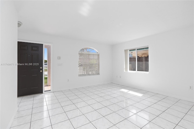 spare room featuring light tile patterned flooring