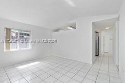 unfurnished room with light tile patterned floors