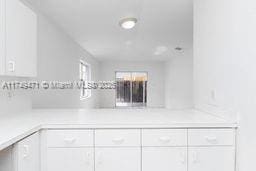 kitchen featuring white cabinetry and light countertops