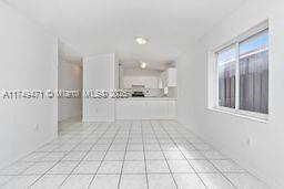 unfurnished living room with light tile patterned floors