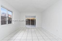 unfurnished room with light tile patterned floors