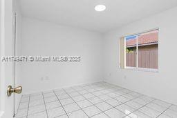 empty room with light tile patterned floors