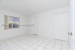 unfurnished room featuring light tile patterned floors