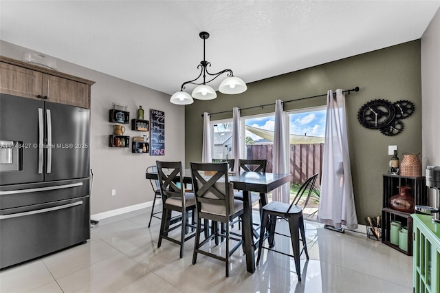 dining room featuring light tile patterned floors and baseboards