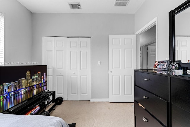 bedroom with light carpet, a closet, and visible vents