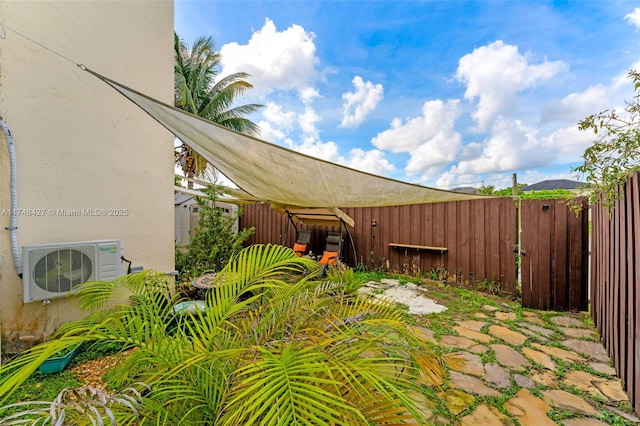 view of yard featuring ac unit and fence