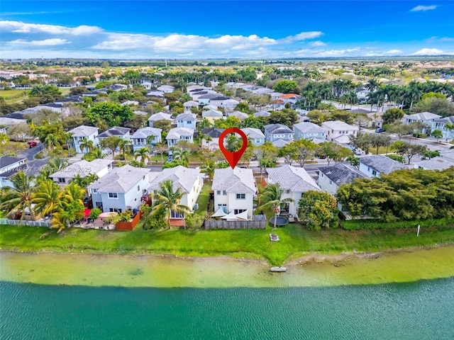 drone / aerial view featuring a water view and a residential view