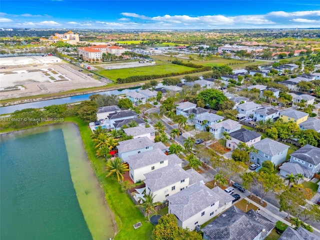 drone / aerial view featuring a residential view and a water view