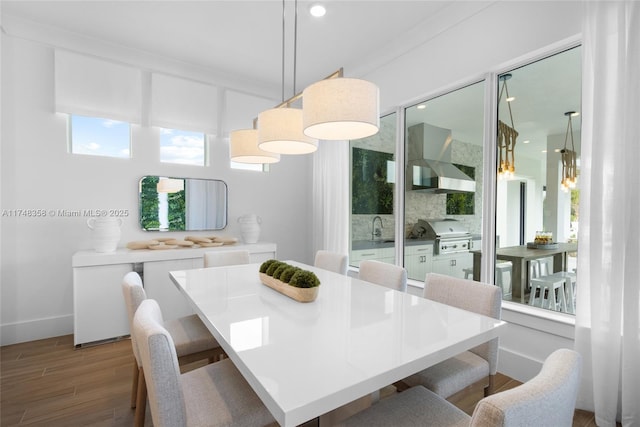 dining room with baseboards and wood finished floors