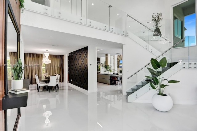 foyer featuring stairway and a high ceiling