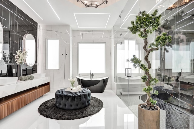 full bath featuring a soaking tub, tile walls, a stall shower, and vanity