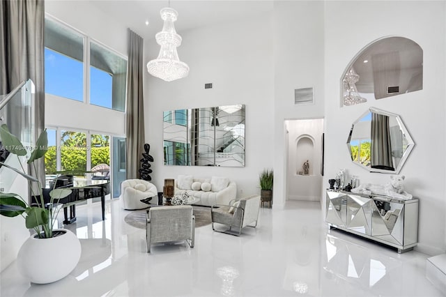 living area featuring a high ceiling and visible vents