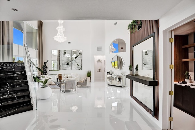 living area featuring visible vents and a towering ceiling