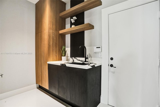 interior space with baseboards and vanity