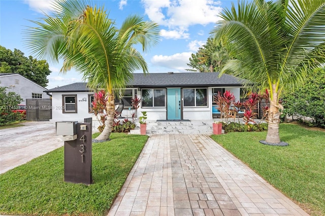 431 NE 110th Ter, Miami, FL 33161 - single story home featuring a front lawn, stucco siding, and roof with shingles