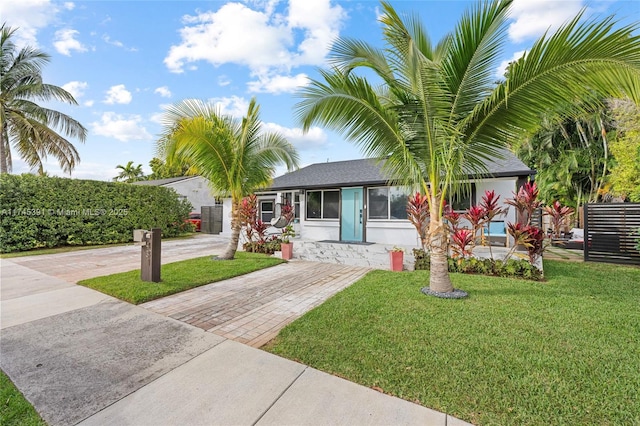 431 NE 110th Ter, Miami, FL 33161 - view of front of property featuring a front lawn, driveway, and stucco siding