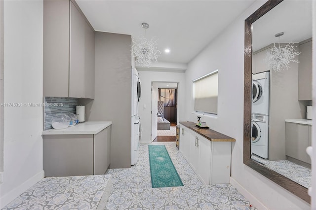431 NE 110th Ter, Miami, FL 33161 - full bathroom featuring stacked washer / drying machine, a chandelier, ensuite bath, decorative backsplash, and recessed lighting