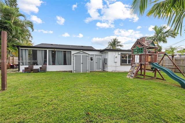 431 NE 110th Ter, Miami, FL 33161 - rear view of house with a sunroom, a playground, and a storage unit