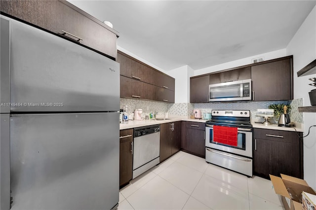 100 Bayview Dr Unit 2014, Sunny Isles Beach, FL 33160 - kitchen featuring dark brown cabinetry, light countertops, backsplash, and appliances with stainless steel finishes