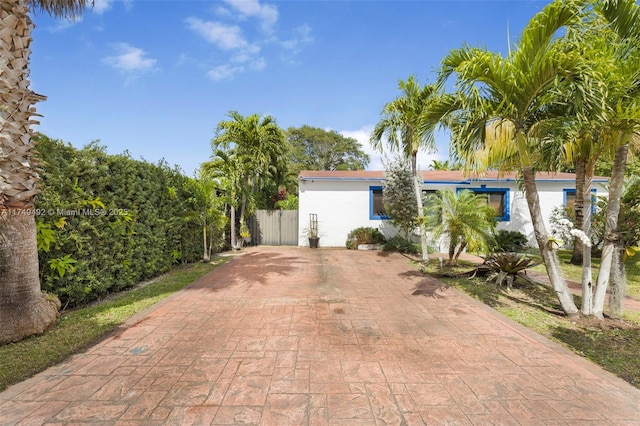 exterior space featuring fence and stucco siding