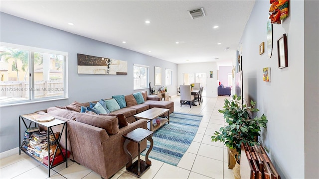 living room with light tile patterned floors, baseboards, visible vents, and recessed lighting