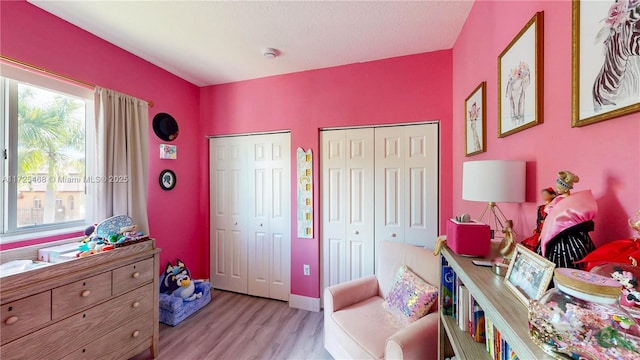 interior space featuring multiple closets and light wood-type flooring