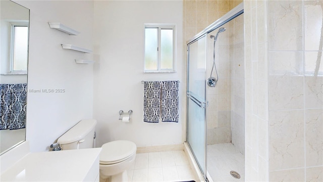 full bath with tile patterned flooring, toilet, vanity, baseboards, and a shower stall
