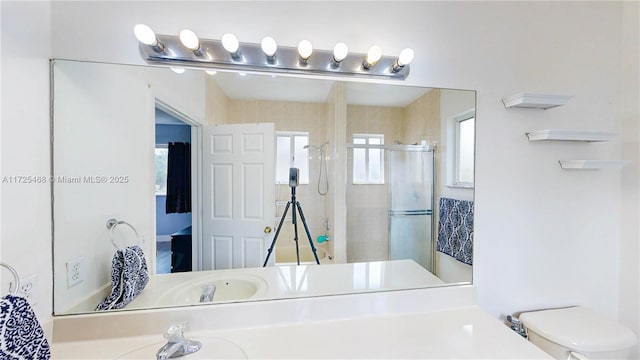 full bathroom with a shower stall, toilet, and vanity