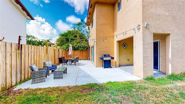 view of patio featuring an outdoor hangout area and a fenced backyard