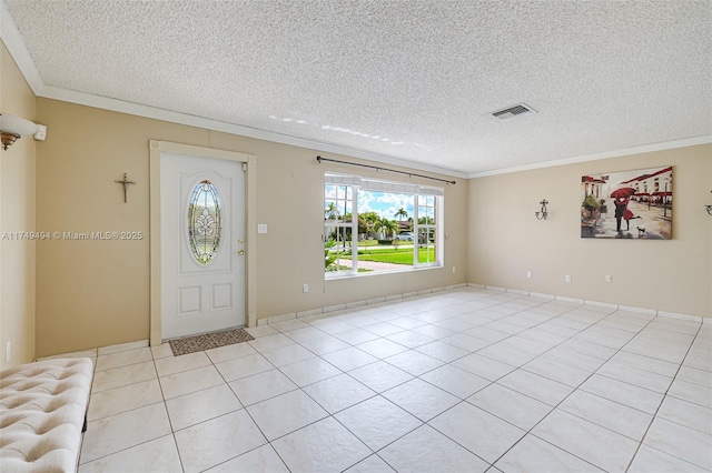 entrance foyer featuring light tile patterned floors, a textured ceiling, and crown molding