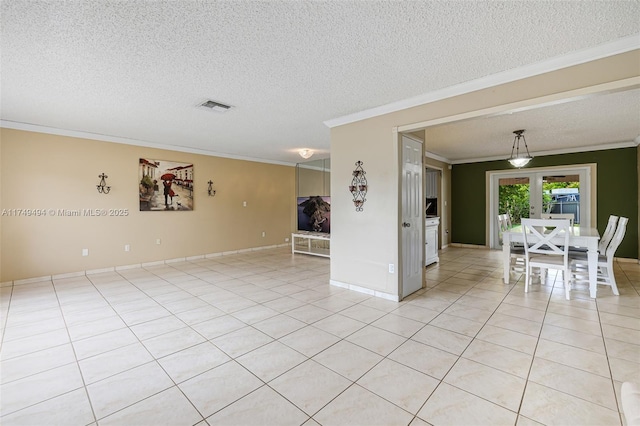 spare room with light tile patterned floors, visible vents, ornamental molding, a textured ceiling, and french doors