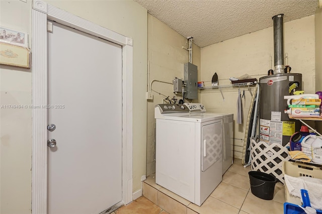 laundry room featuring a textured ceiling, laundry area, washer and dryer, water heater, and electric panel