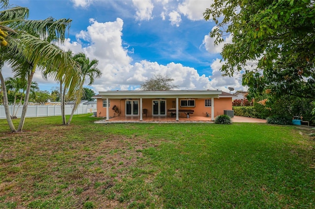 back of house featuring a yard, a patio, french doors, and fence