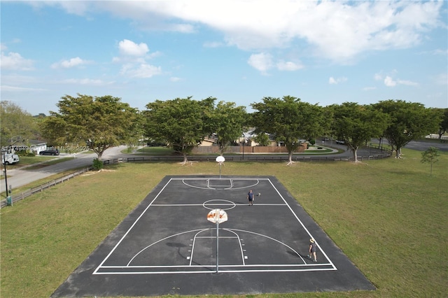 view of home's community with community basketball court, uncovered parking, and a yard