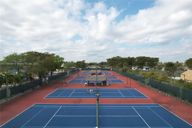 view of tennis court featuring fence