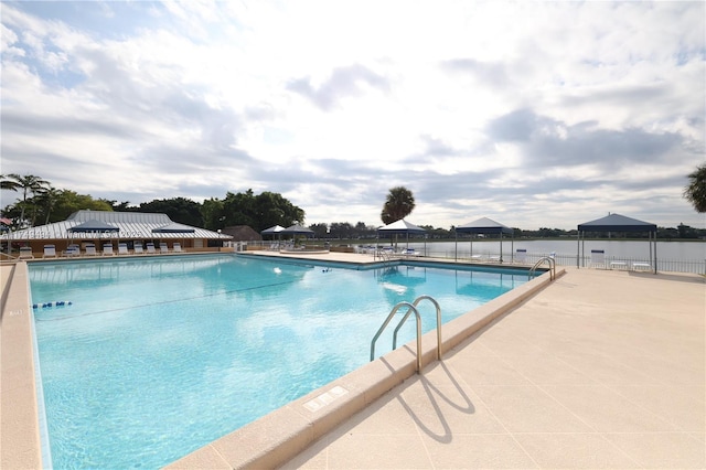 community pool featuring a gazebo, a patio area, and fence