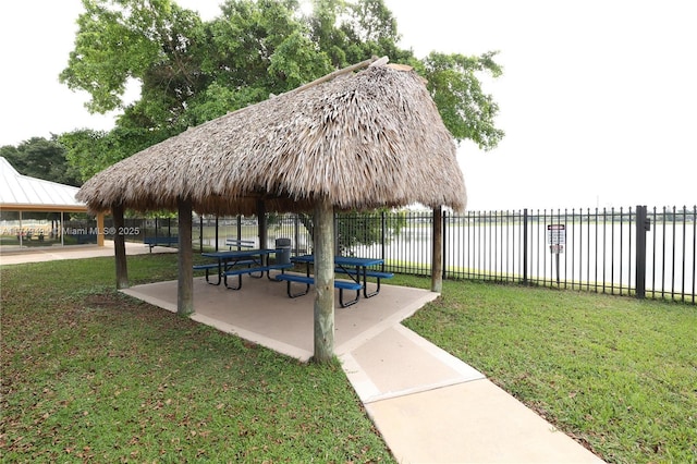 view of community with a gazebo, fence, and a yard