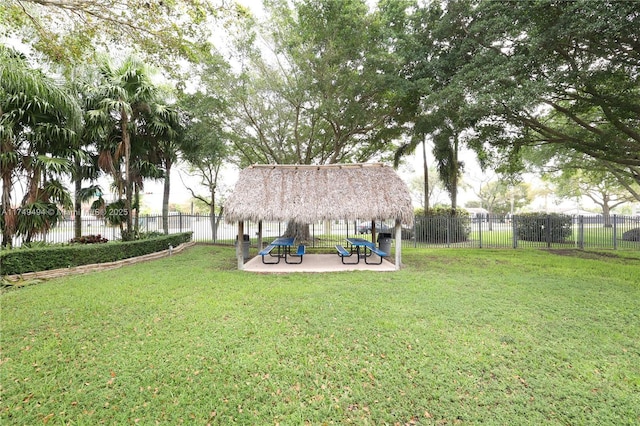 view of yard featuring a fenced backyard, a playground, and a patio