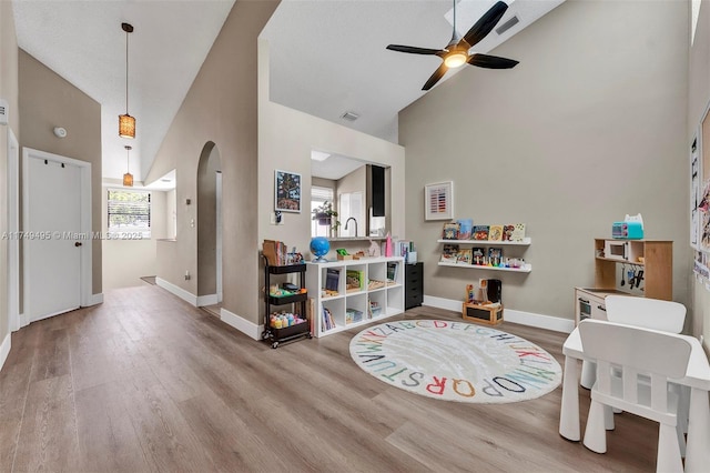 123 NW 98th Ter, Plantation, FL 33324 - playroom with high vaulted ceiling, arched walkways, baseboards, and wood finished floors